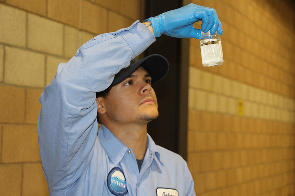 Senior Operator Johnny Bustos checks for water clarity